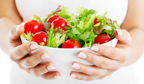 holding a fresh salad